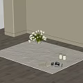 Light Textured Square Rug on Wooden Floor with White Flowers Open Book and Small Candles