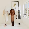 Three Mannequins Displaying Stylish Outfits With Accessories Near Window And Decorative Painting