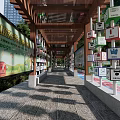 Wooden Pergola Structure With Promotional Posters In Community Plaza Near High Rise Buildings