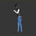 Woman With Black Hair In Black Jacket And Blue Pants Standing Against Gray Background