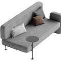 Modern Gray Sofa with Gray and Brown Pillows and Small Round Side Table