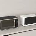Modern Kitchen Appliances With Black And White Microwave Ovens On Countertop