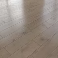 Light Brown Polished Wooden Floor With Smooth Surface And Wood Grain Patterns