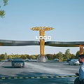 Modern Entrance Gate with Golden Tree Shaped Structure and LOGO Surrounding Trees Vehicles Passing By