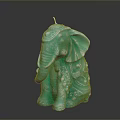 Turquoise Elephant Shaped Candle With Intricate Decorative Details On Black Background