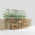 Two Outdoor Chairs with Small Table and Bamboo Plants Behind Lattice Fence