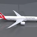 Qantas White Passenger Plane with Red Tail Fin Parked in Airport Hangar with Reflective Floor