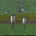 Outdoor Pillar Lights with White Lampshades on Grass and Trees Hedges Background