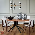 Modern Wooden Round Dining Table With White Chairs Vases Black Decorative Bowl And Chandelier