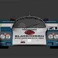 White Racing Car With Blue Pink Stripes Numbers 21 27 Sponsor Blackthorn Porsche Sleek Design