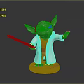 Green Yoda Toy Figure With White Robe Orange Outfit And Green Lightsaber On Orange Base