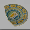 Chipped Ornate Ceramic Plate With Yellow Blue Green Patterns And Central Fish Design