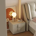 Modern Beige Nightstand With Round Lamp Books And Bedside Artwork