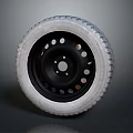 Tire With Black Wheel Rim Featuring Multiple Holes And Tread Pattern