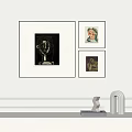 Modern Interior Decor With Three Framed Artworks And Sculptures On Shelf