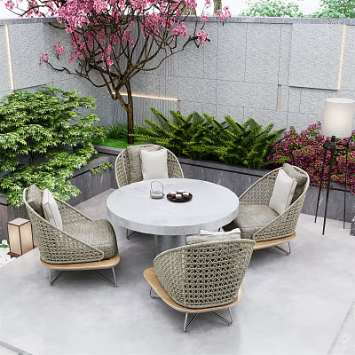 Round Outdoor Table With Four Wicker Chairs In Garden With Green Plants And Stone Wall 3d model