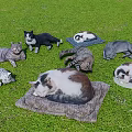 Realistic Cat Statues on Green Grass with Various Poses and Colors