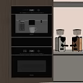 Modern Kitchen With Black Built In Oven And Stainless Steel Coffee Grinders On Countertop