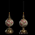 Vintage Floral Pattern Candle Holders With Lit Candles And Metal Bases On Black Background