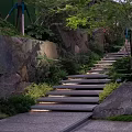 Natural Entrance Gate With Stone Steps Lush Greenery And Rock Elements
