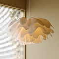 Petal Shaped Cream Colored Pendant Light Hanging By Window With Blinds And Soft Glow