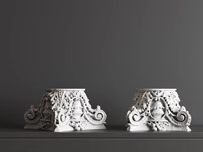 White Decorative Capitals with Intricate Carvings on Black Surface and Gray Background 3d model