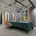 Modern Curtain and Fabric Showroom With Various Colored Fabrics Table Chairs and Plants
