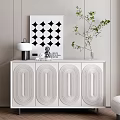 Modern White Entryway Side Cabinet with Carved Panels Lamp Sculpture Green Plant and Wall Art