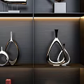 Modern Decorative Ornament Set on Lit Black Shelves with Metallic and Geometric Designs