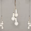 Stylish Pendant Lights with White Bulbs and Gold Hanging Wires Against Gray Wall Background