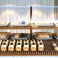 Freshly Baked Bread and Pastries Displayed on Wooden Shelves with Assorted Loaves Rolls and Treats