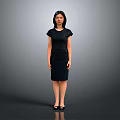 Elegant Woman In Black Dress Standing Against Gray Background With Confident Pose And Heels