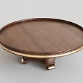 Round Dark Wood Coffee Table With Golden Trim And Intricate Carved Base