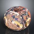 Colorful Spherical Sculpture with Intricate Textures Multicolored Surface Central Hole and Artistic Carving Details