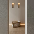 Rattan Stool with White Cushion on Wooden Floor by Gray Wall and Two Wall Lamps