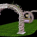Decorative Event Archway Adorned With Pink Flowers Green Grass And Small Table
