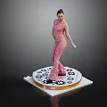 Woman Standing in Pink Patterned Outfit on Circular Platform with Gear Patterns Against Dark Background