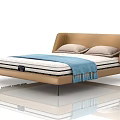Modern Double Bed With Leather Headboard Light Gray Pillows And Blue Tassel Blanket