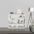 White Modern Bookcase With Geometric Shelves Holding Books And Decorative Items