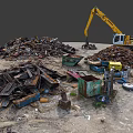 Yellow Excavator Operating At Scrap Metal Recycling Yard With Piles Of Waste And Blue Dumpsters