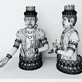 Two white decorative sculptures with headdress earrings and lotus base