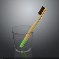 Children's Toothbrush With Yellow Handle Green Bottom Brown Bristles In Glass Cup
