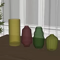 Colorful Textured Vases Arranged On Light Table With Green Plants In Bright Room