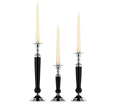 Three Candle Holders With Black Bases Silver Accents And White Candles 3d model