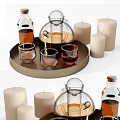 Glass cups displayed on wooden tray with candles and bottles in home decor setting