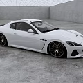 White Maserati Coupe With Sleek Exterior Design And Black Alloy Wheels In Modern Indoor Space