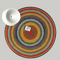 Colorful Round Area Rug With Concentric Stripes And White Bowl On White Surface