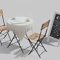 Round Table with Wooden Chairs Checkered Tablecloth Cups Open Book and Chalkboard Sign