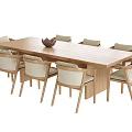 Natural Wooden Long Dining Table With Light Colored Cushioned Chairs And Decorative Bowl