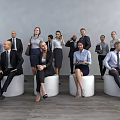 Group of Business Professionals Standing and Sitting in Office With Gray Wall and Wooden Floor